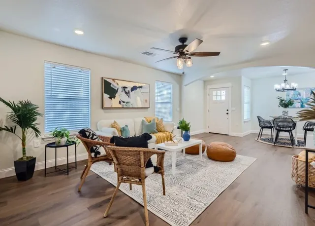 a dining room with wooden floor and a chandelier