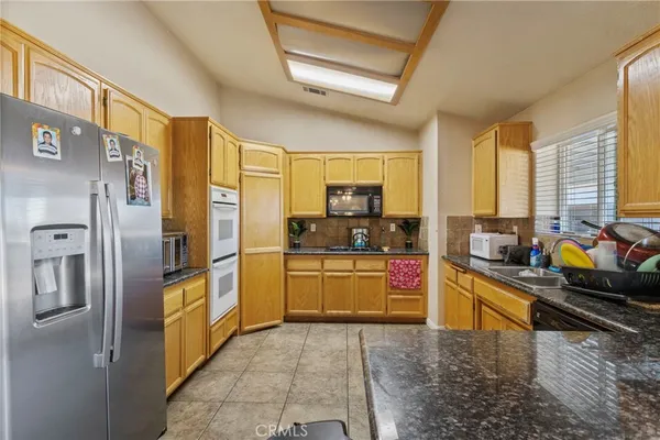 a kitchen filled with a sink a counter and appliances