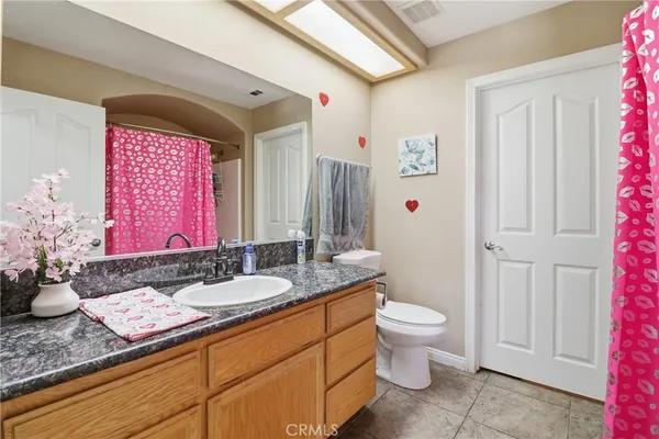 a bedroom with a bed and a dresser in it