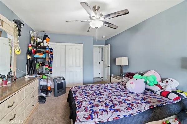 a room with furniture a rug and white walls