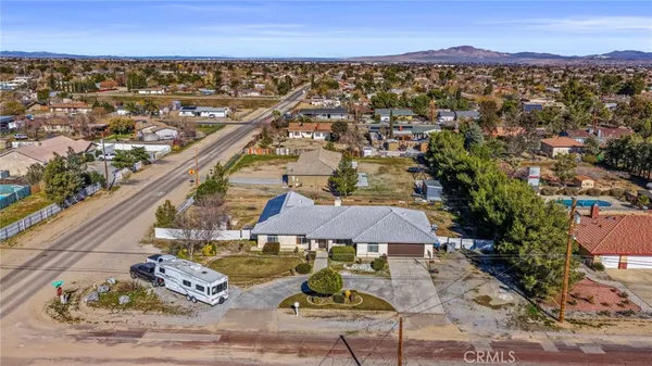 an aerial view of a house with garden space and street view