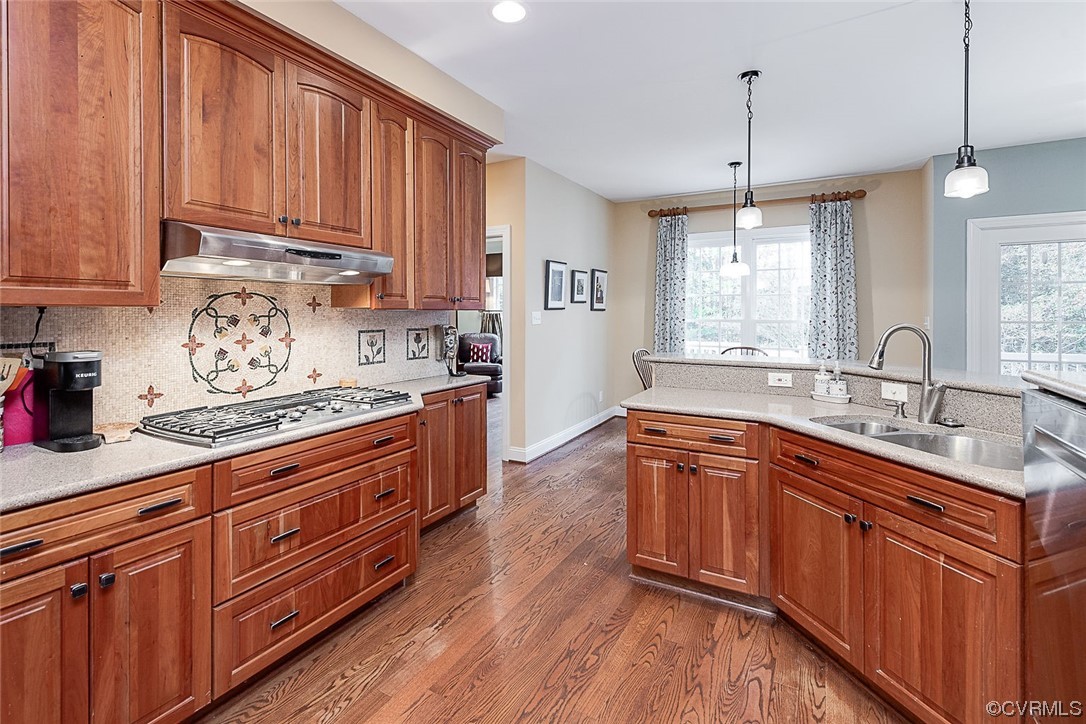 113 Grenelefe Williamsburg, VA 23188 - Photo 17 of 44 a kitchen with stainless steel appliances granite countertop wooden cabinets a sink and dishwasher with wooden floor