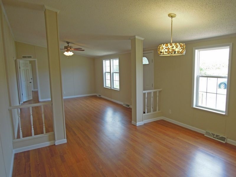 781 Concord Church Road Timberville, VA 22853 - Photo 6 of 18 an empty room with wooden floor and windows