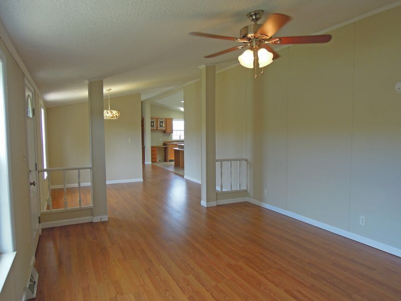 781 Concord Church Road Timberville, VA 22853 - Photo 7 of 18 a view of an empty room with window wooden floor and a chandelier