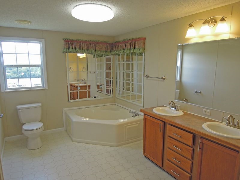 781 Concord Church Road Timberville, VA 22853 - Photo 9 of 18 a spacious bathroom with a tub sink and mirror