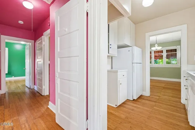 a view of a hallway with wooden floor and entryway