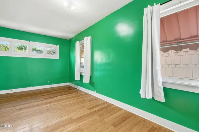 a view of a room with wooden floor and a fireplace