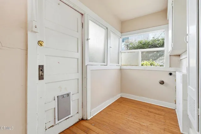 wooden floor in an empty room with a window