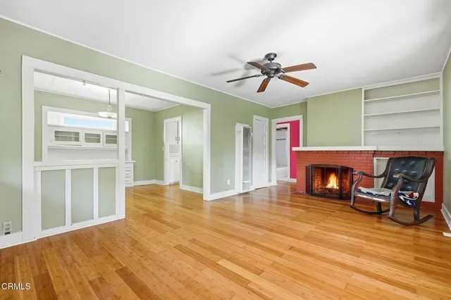 a view of a livingroom with a fireplace and dining room