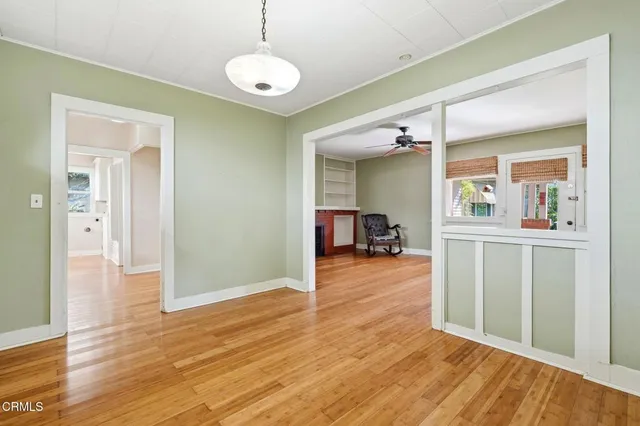 a view of a livingroom with wooden floor and furniture