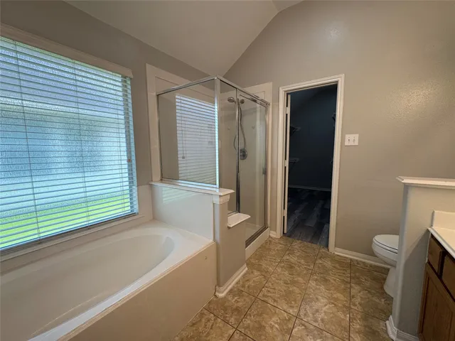 a bathroom with a tub and a toilet