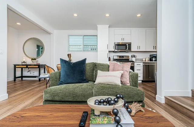 a living room with furniture and a wooden floor