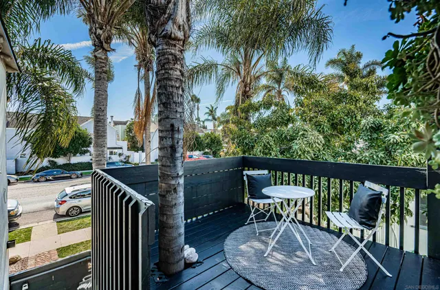 a view of a chair and tables in the balcony