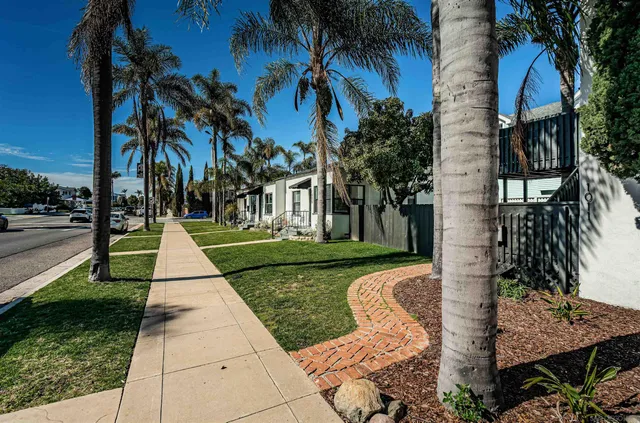 a kitchen with stainless steel appliances a dining table chairs and couches