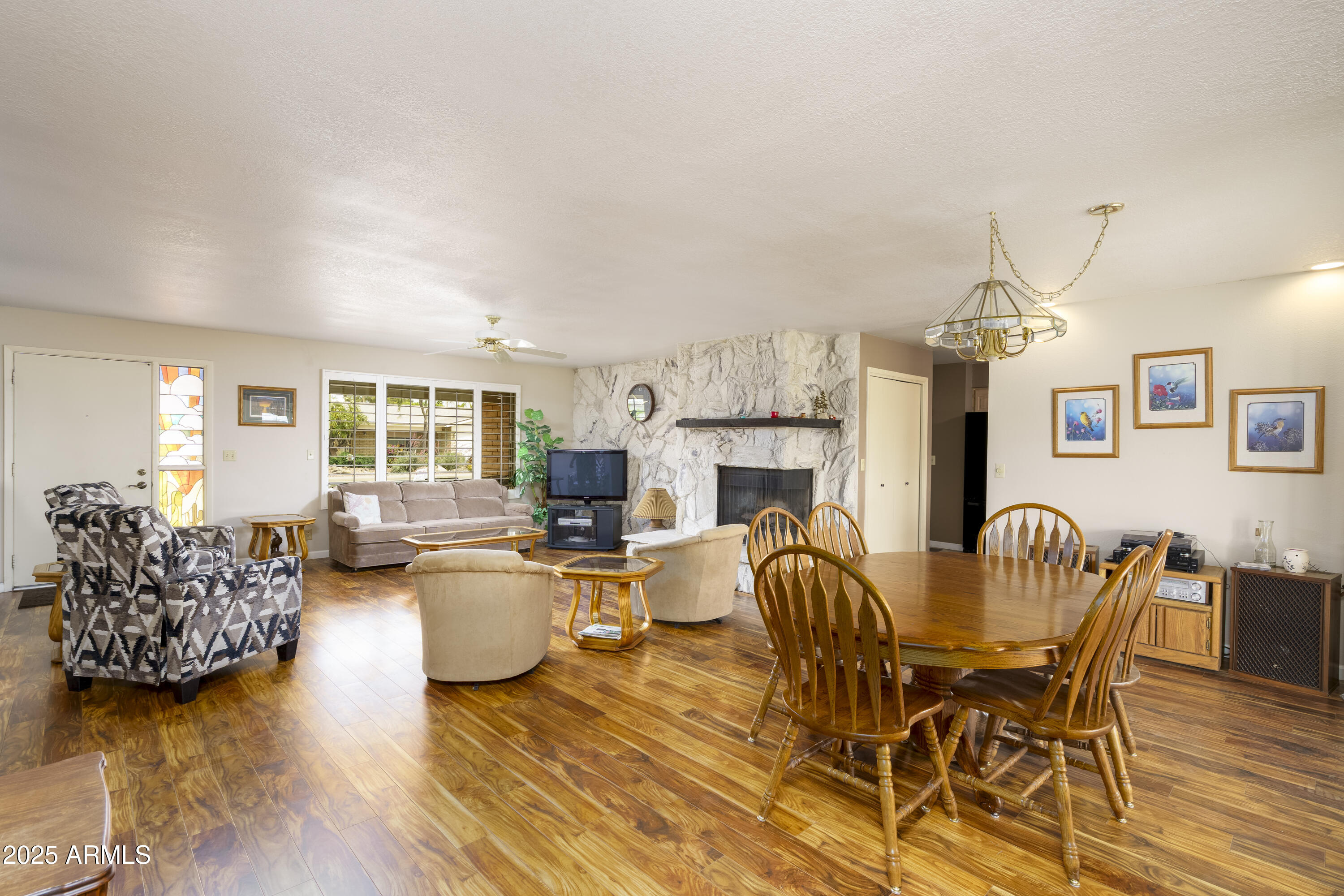 518 South Racine Mesa, AZ 85206 - Photo 5 of 24 a living room with furniture a fireplace and a chandelier