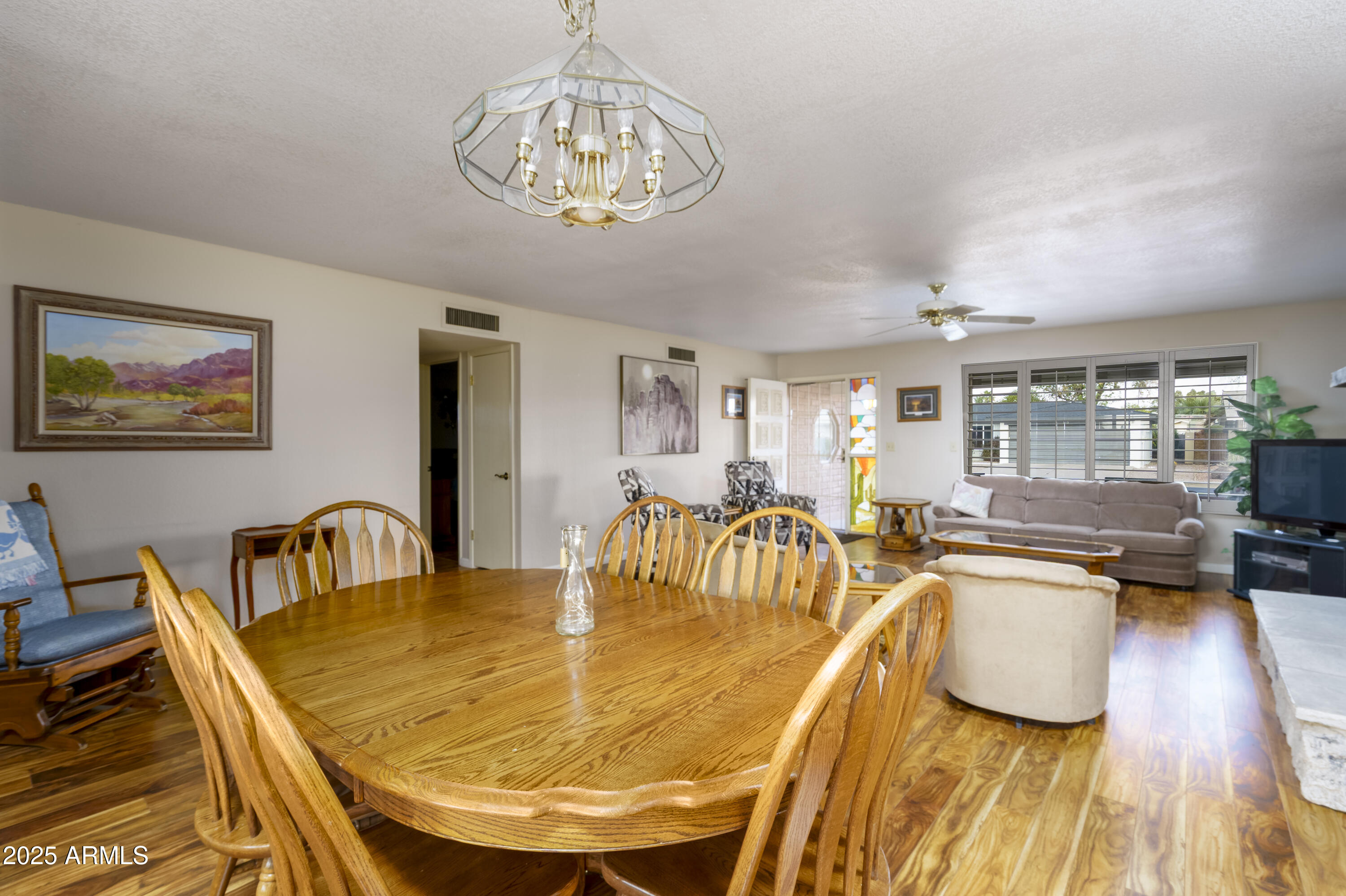 518 South Racine Mesa, AZ 85206 - Photo 6 of 24 a dining room with wooden floor and a chandelier
