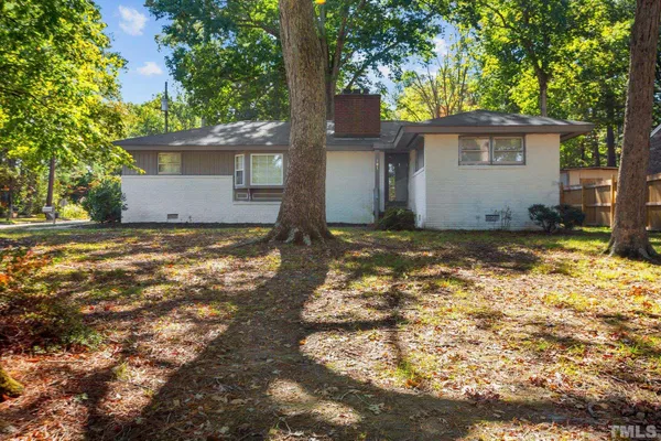 a view of a house with a tree in the background