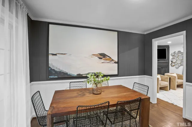 a dining room with furniture and wooden floor