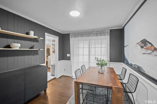 a dining room with furniture and window