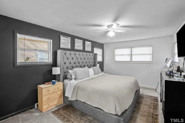 a bedroom with a bed and a tv