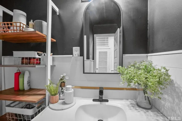 a bathroom with a sink and a mirror