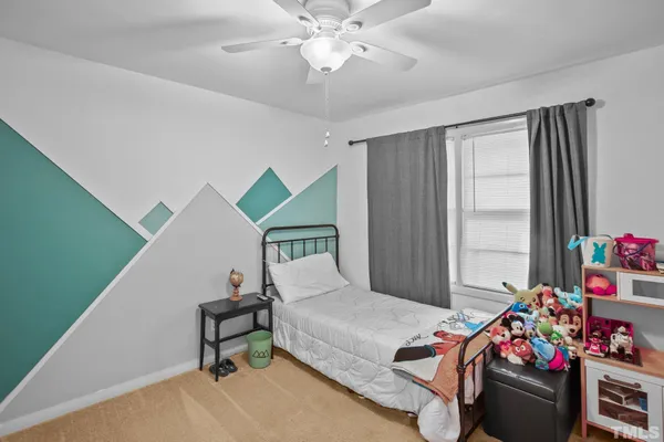 a bedroom with bed and a window