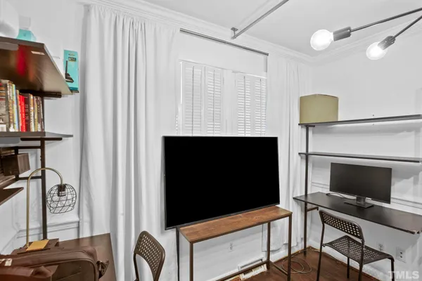 a view of a livingroom with furniture and a window