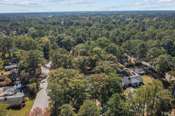 an aerial view of a residential house with a street