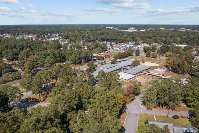 an aerial view of residential building with green space