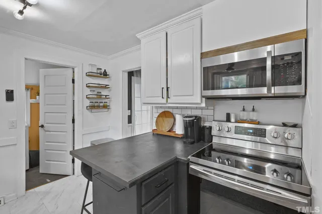 a kitchen with granite countertop a stove and a sink