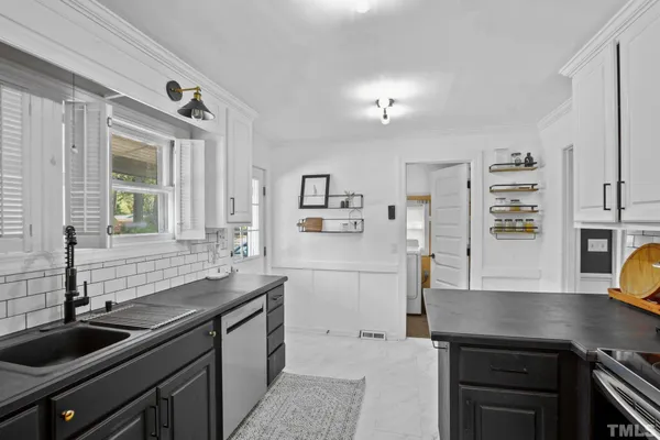 a kitchen with granite countertop a sink and cabinets