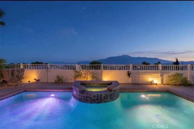 a view of a swimming pool with an outdoor seating