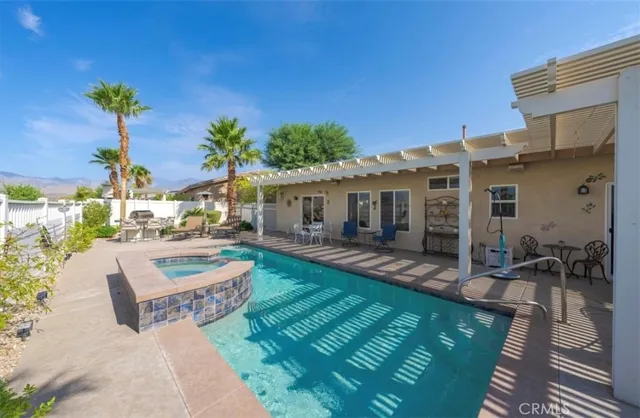 a view of a house with backyard and sitting area