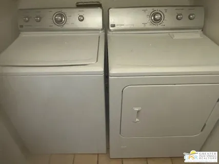 a bathroom with a granite countertop sink toilet a mirror and vanity