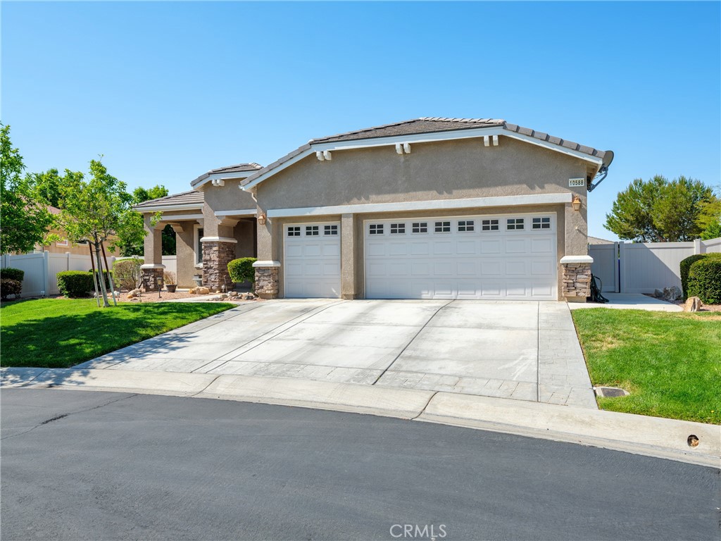10588 Archerwill Road Apple Valley, CA 92308 - Photo 1 of 35 a front view of a house with a yard and garage