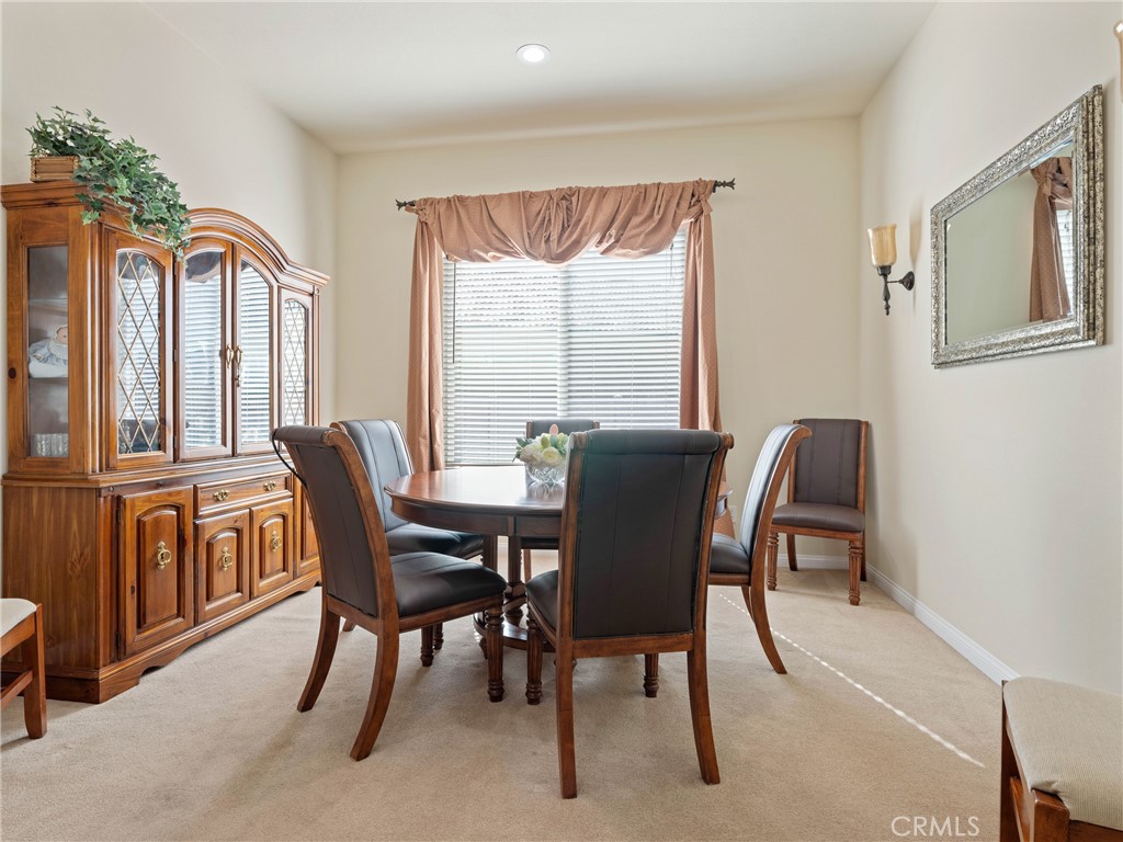 10588 Archerwill Road Apple Valley, CA 92308 - Photo 13 of 35 a view of a dining room with furniture and a window