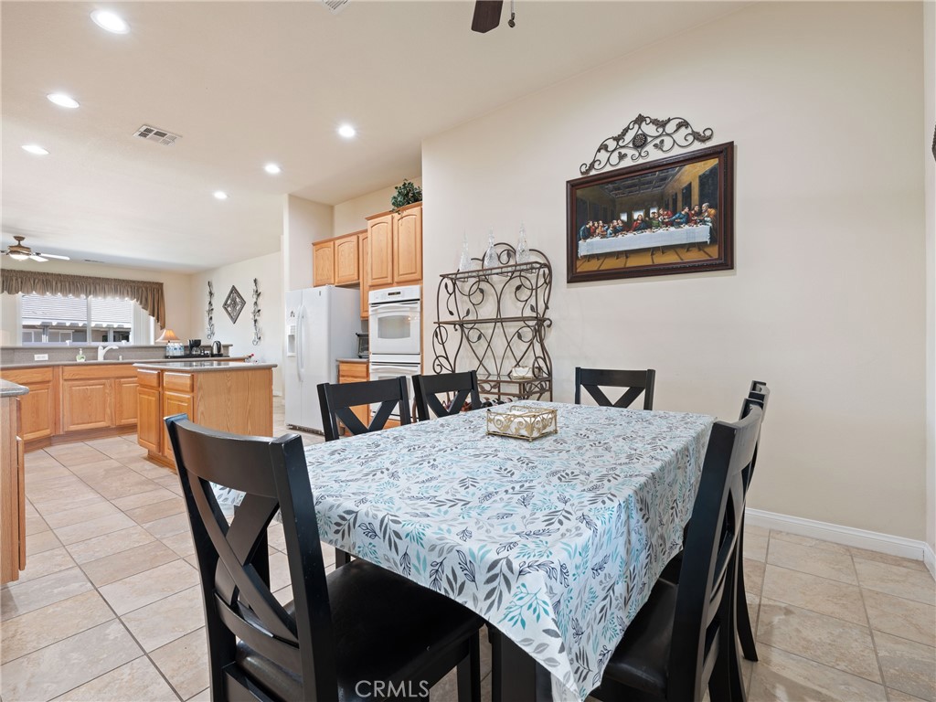 10588 Archerwill Road Apple Valley, CA 92308 - Photo 18 of 35 a dining room with furniture and wooden floor