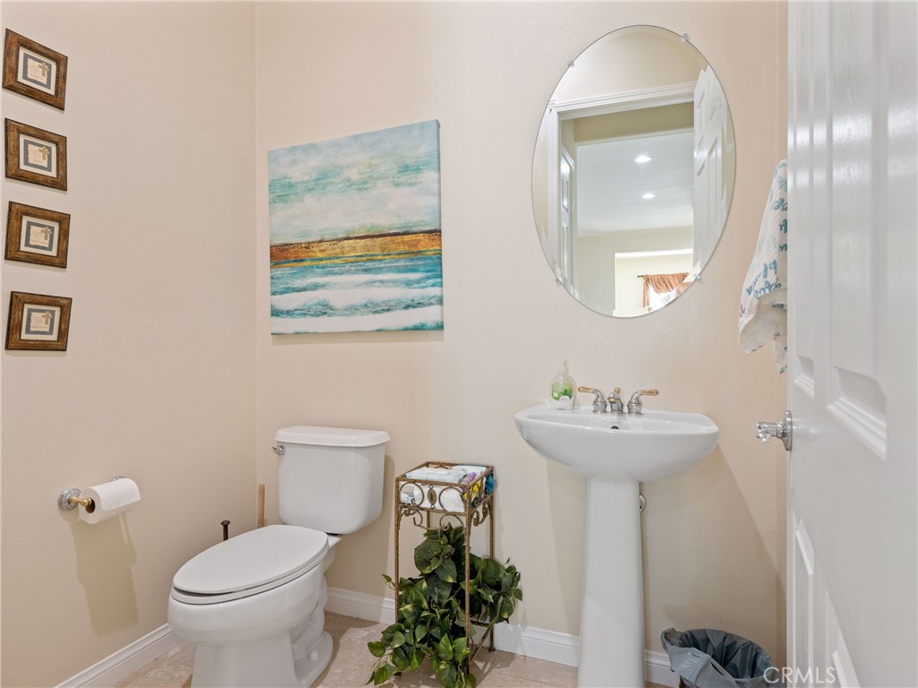 10588 Archerwill Road Apple Valley, CA 92308 - Photo 21 of 35 a bathroom with a toilet sink and mirror
