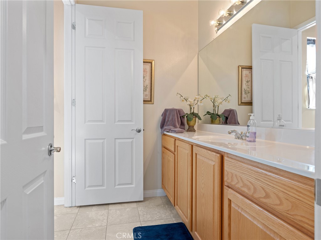 10588 Archerwill Road Apple Valley, CA 92308 - Photo 28 of 35 a bathroom with a double vanity sink and a mirror