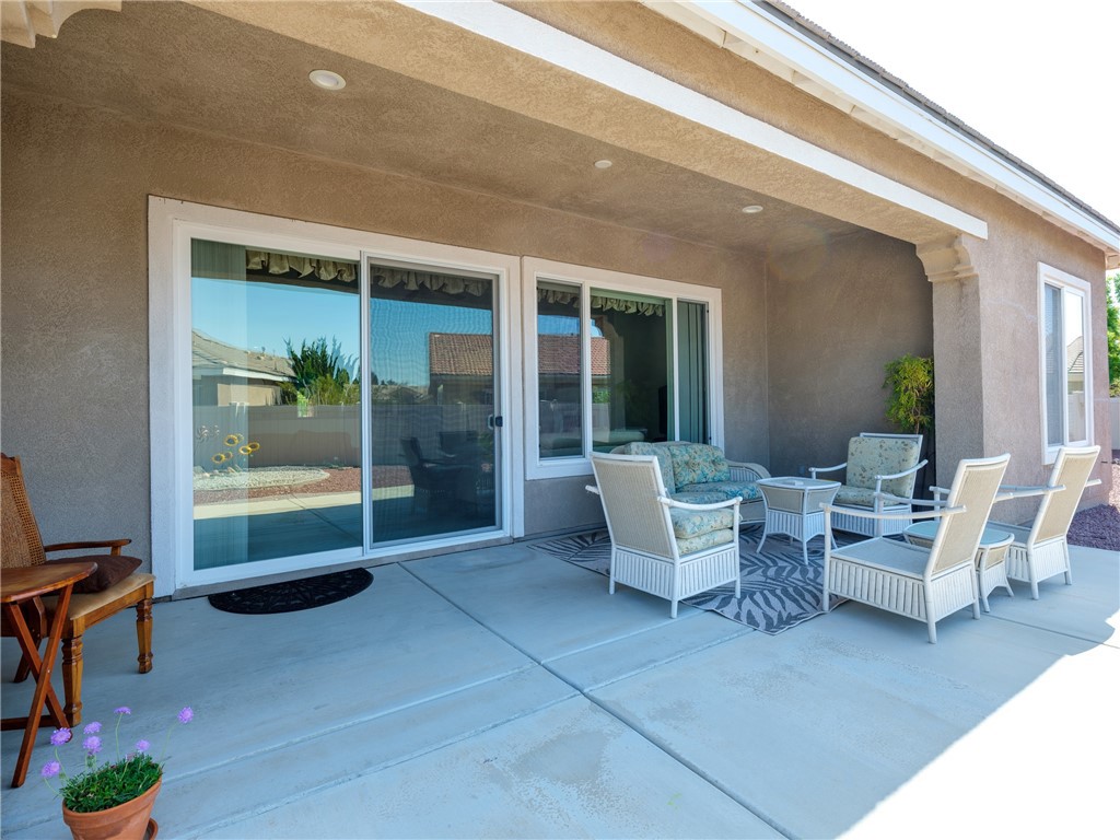 10588 Archerwill Road Apple Valley, CA 92308 - Photo 30 of 35 a living room with patio furniture and a potted plant