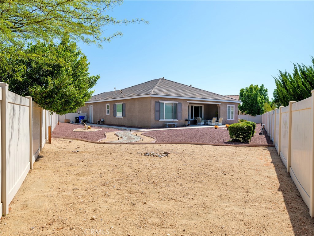 10588 Archerwill Road Apple Valley, CA 92308 - Photo 31 of 35 a front view of a house with a yard and garage