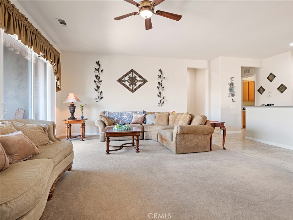 10588 Archerwill Road Apple Valley, CA 92308 - Photo 6 of 35 a living room with furniture and a chandelier