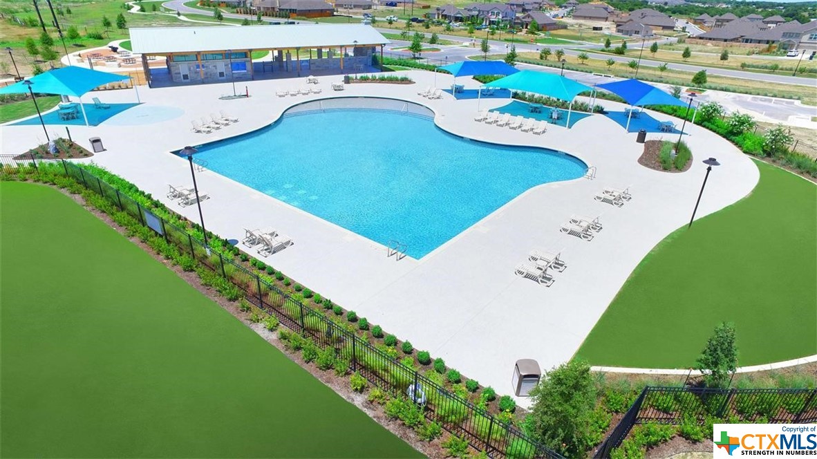 a view of a swimming pool with a yard