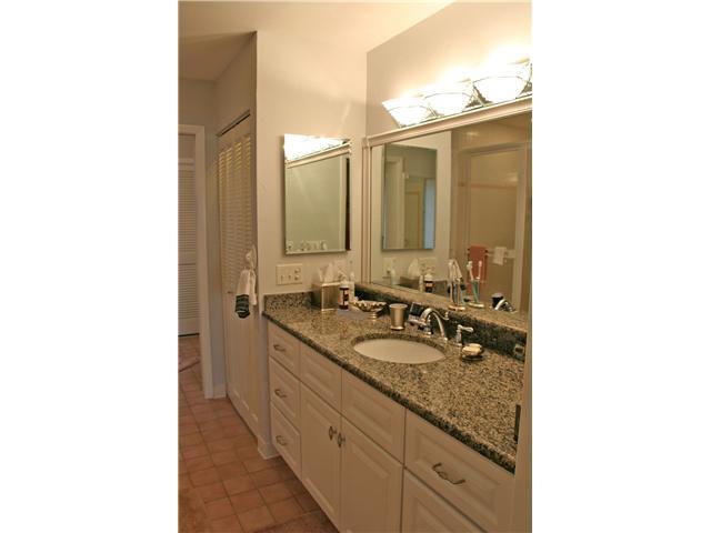2640 Northwest Collins Cove Road Stuart, FL 34994 - Photo 12 of 21 a bathroom with a granite countertop sink and a mirror