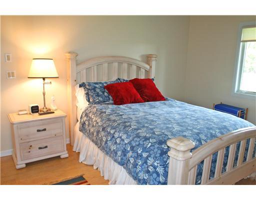 2640 Northwest Collins Cove Road Stuart, FL 34994 - Photo 17 of 21 a bed sitting in a bedroom next to a window