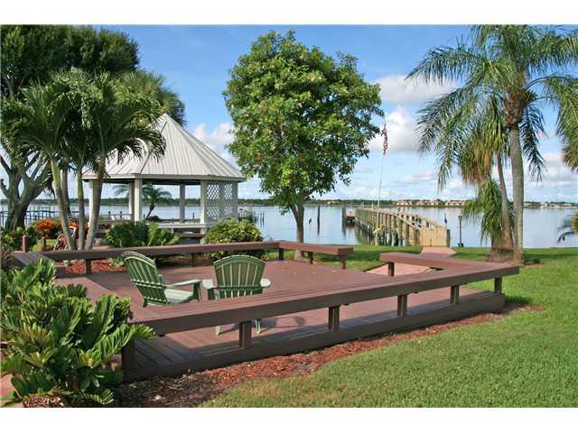 2640 Northwest Collins Cove Road Stuart, FL 34994 - Photo 2 of 21 a view of a bench in a yard