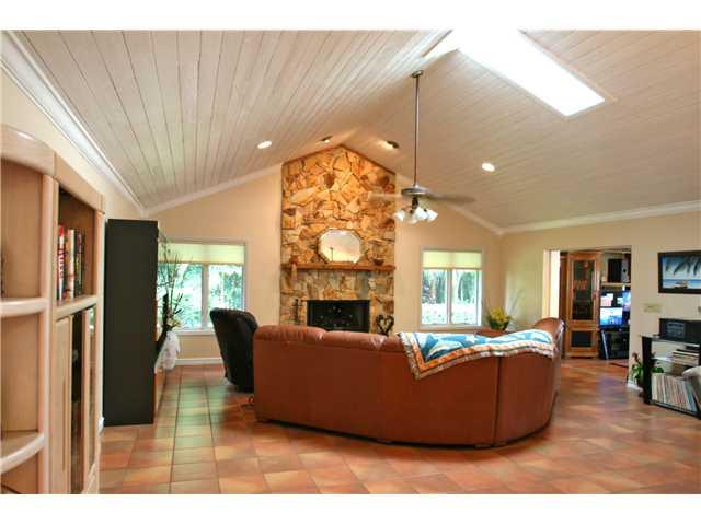 2640 Northwest Collins Cove Road Stuart, FL 34994 - Photo 7 of 21 a living room with furniture a fireplace and a chandelier