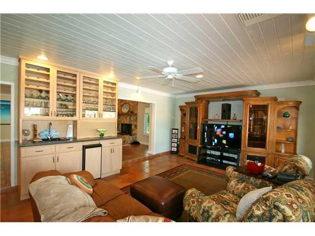2640 Northwest Collins Cove Road Stuart, FL 34994 - Photo 8 of 21 a living room with furniture a large window and bookshelf