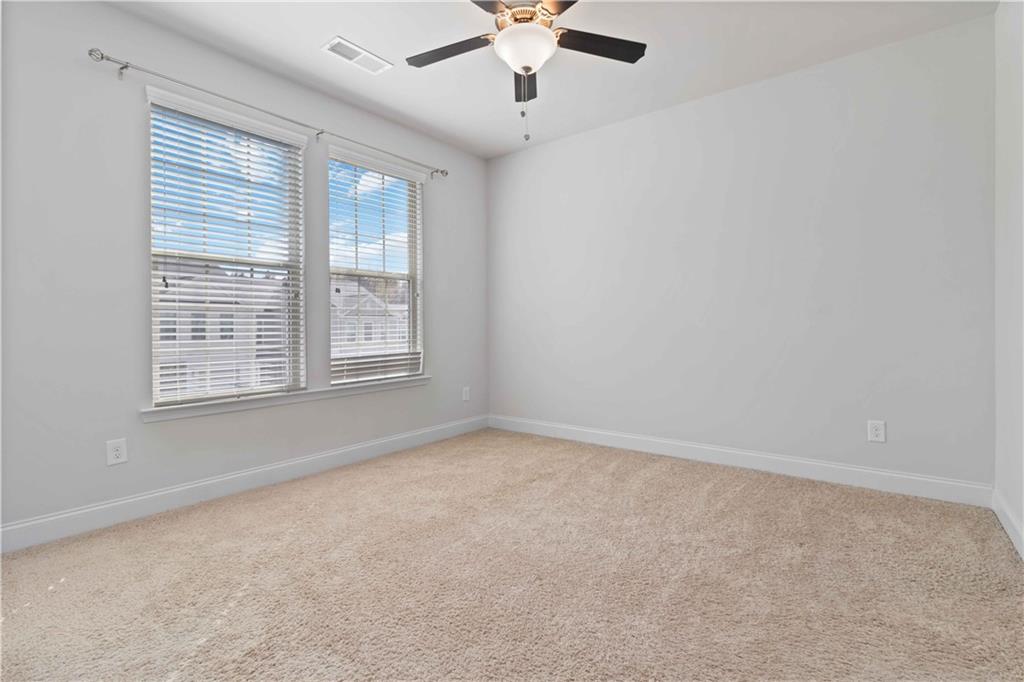 3437 Sumersbe Court Atlanta, GA 30349 - Photo 12 of 25 an empty room with windows and fan