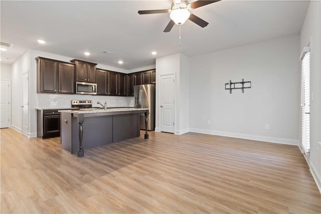 3437 Sumersbe Court Atlanta, GA 30349 - Photo 4 of 25 a kitchen with stainless steel appliances granite countertop a sink a stove and a refrigerator